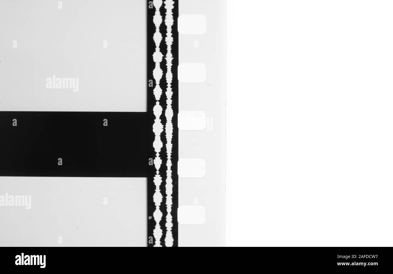 Detail of 35 mm film optical movie sound tracks and perforation gauge black and white cinema background transparent copy space Stock Photo