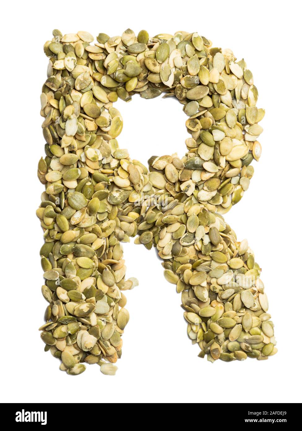 Letter R of the English alphabet from pumpkin seeds on a white isolated ...