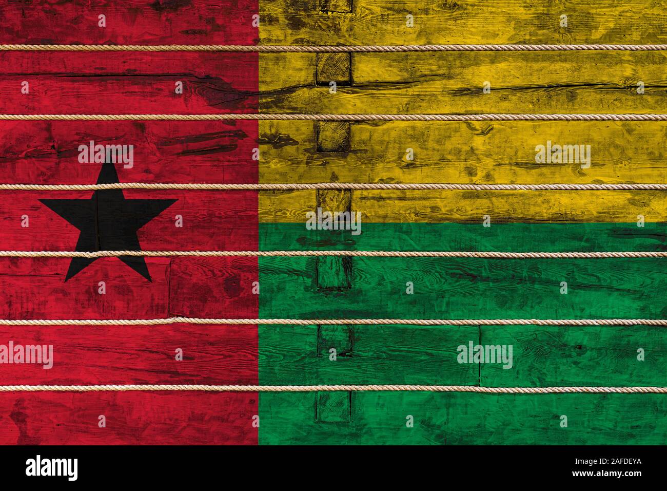 National flag of Guinea Bissau on a wooden wall background. The concept ...