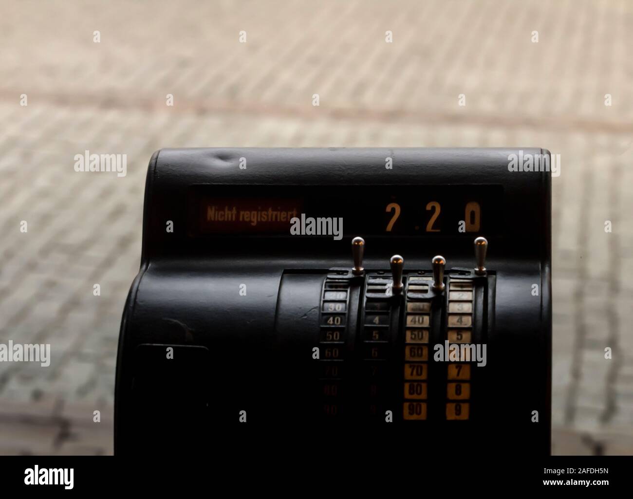 Close up of a cash register machine with some numbers and German words saying 'not registered'. Stock Photo