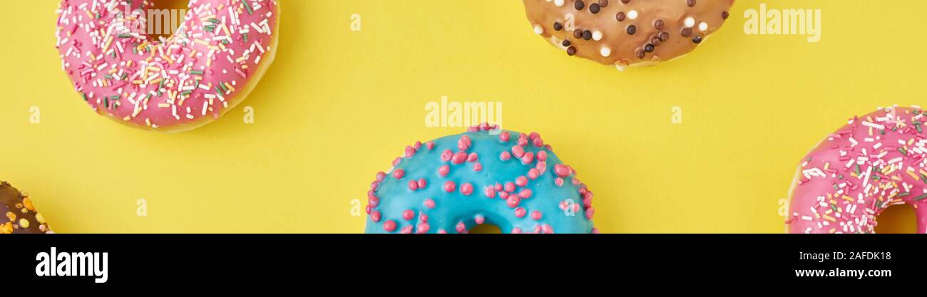Color donut pattern on yellow background, long banner Stock Photo - Alamy