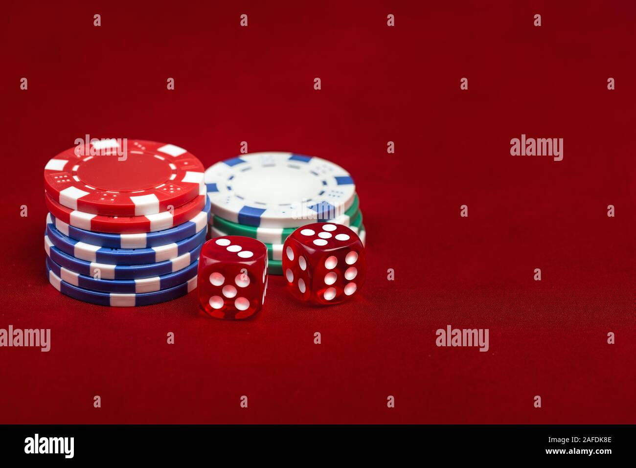 Dices and casino chips on red background. Gambling concept Stock Photo