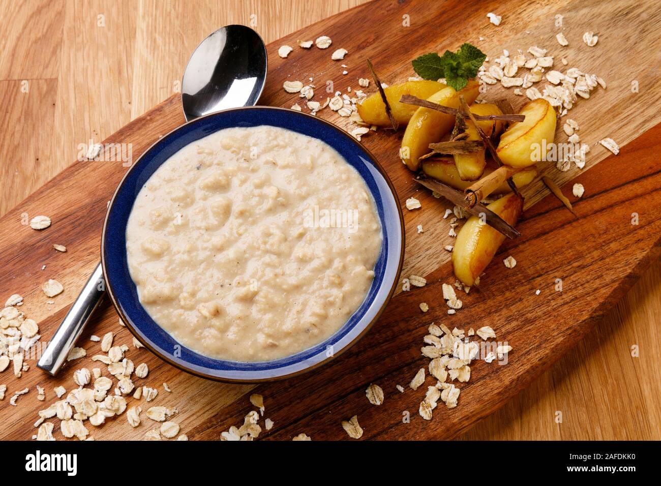 Calorie controlled breakfast of delicious apple and cinnamon porridge, shot on a wooden background Stock Photo