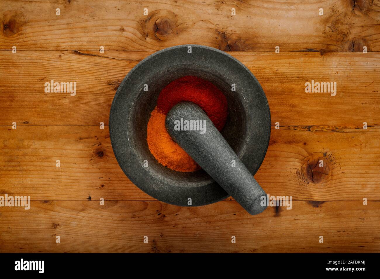 Plan view of pestle & morter and ground spices, shot on a wooden background, with space for copy Stock Photo