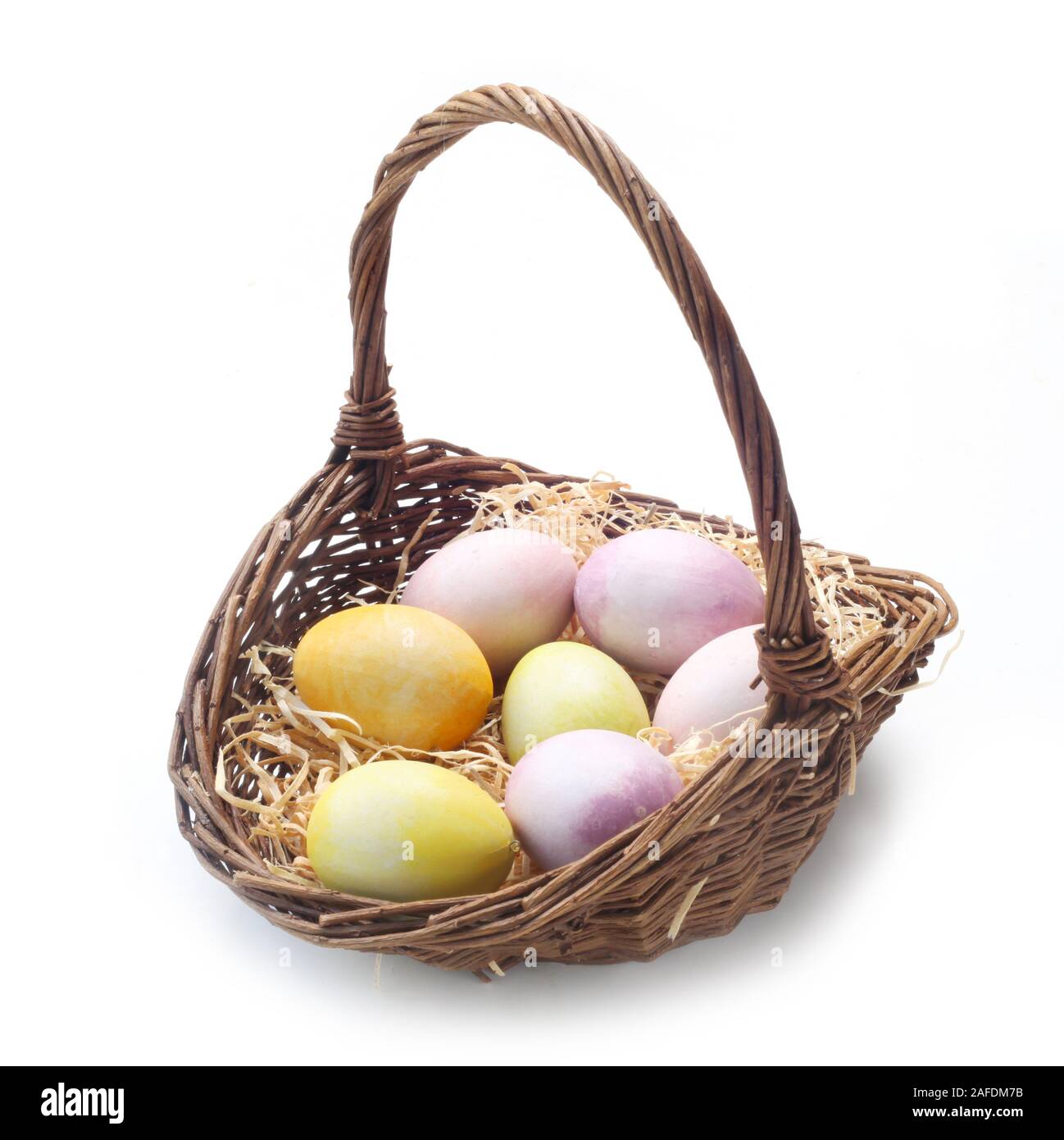 Easter Eggs In A Wicker Basket Isolated On White Stock Photo - Alamy