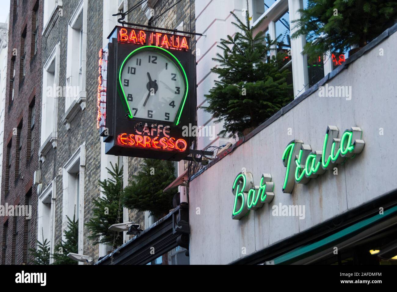 The clock outside Bar Italia, the traditional and world-famous Italian coffee shop sign on Frith Street, Soho London, UK Stock Photo