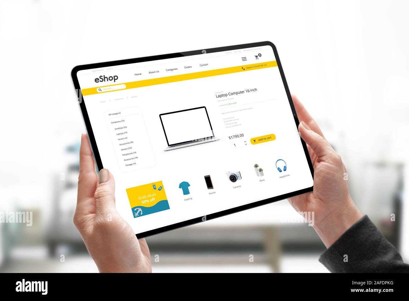 Online shopping website concept on tablet in woman hands. Woman search for laptop computer online Stock Photo