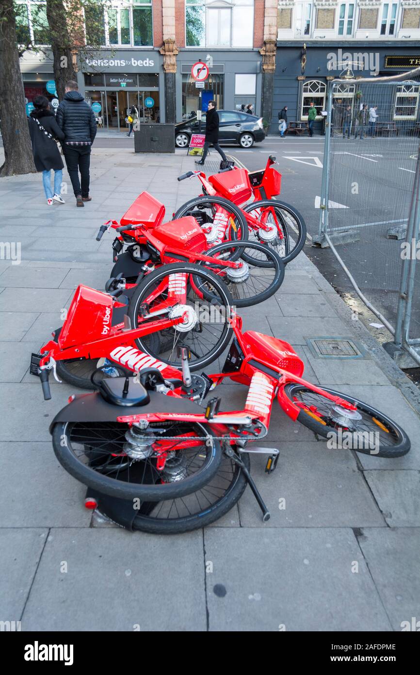 A row of Jump bikes blown over in the windy weather Britain has been experiencing recently Stock Photo
