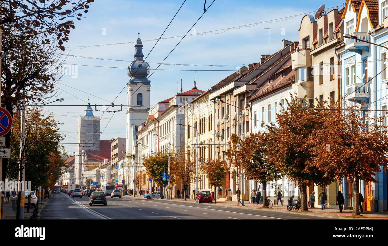 21 Decembrie 1989 with traffic and historcal buildings on a sunny afternoon. The avenue is part of the Cluj-Napoca Old Town. Cluj-Napoca, Romania. Stock Photo