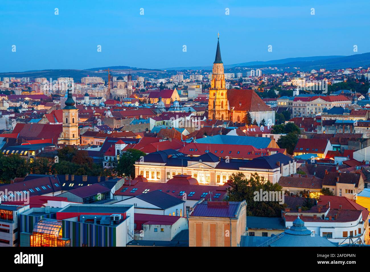 Aerial view of the Cluj Napoca old town with the bell towers of the Saint Michael's church and the Franciscan church during sunset. Romania. Stock Photo
