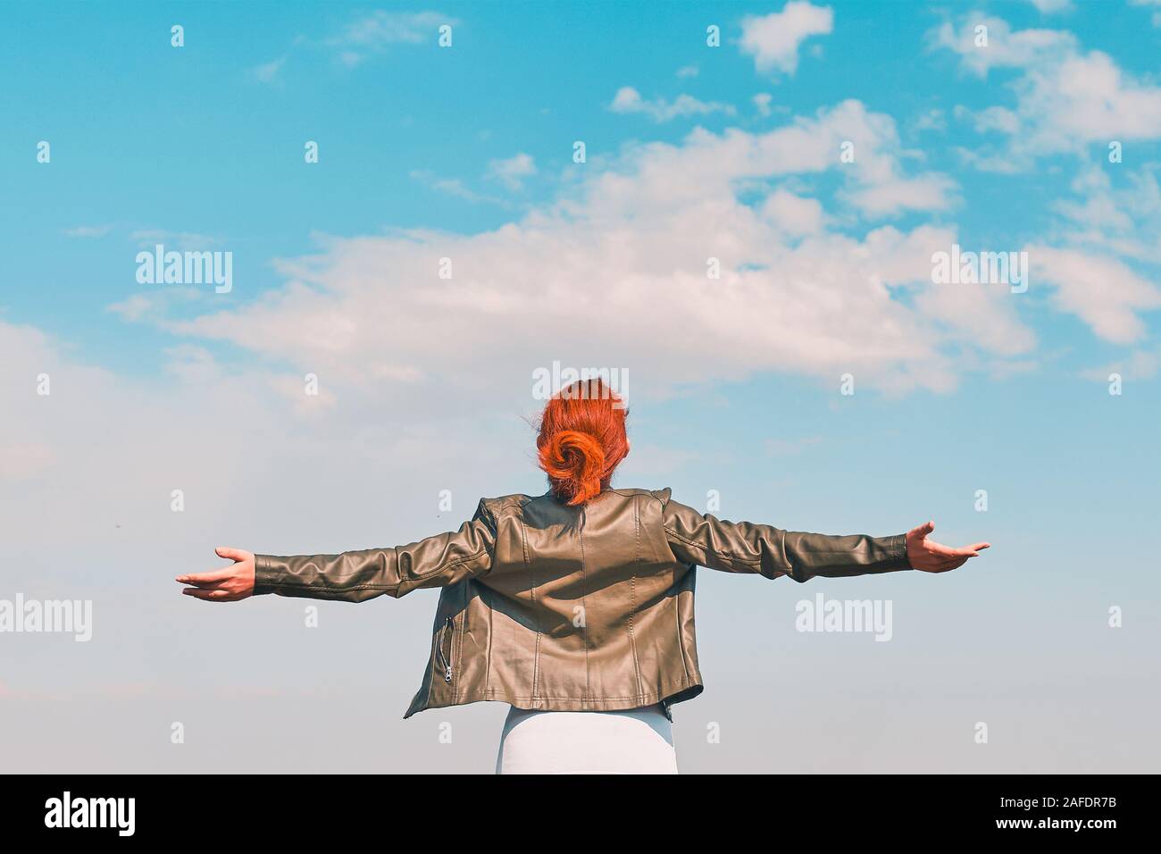 Young woman spreading arms sky hi-res stock photography and images - Alamy