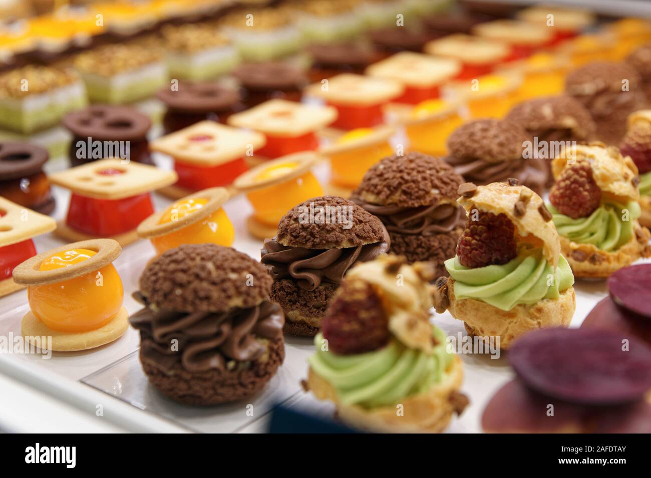 Various sweet items in window display in bakery or supermarket, close-up Stock Photo