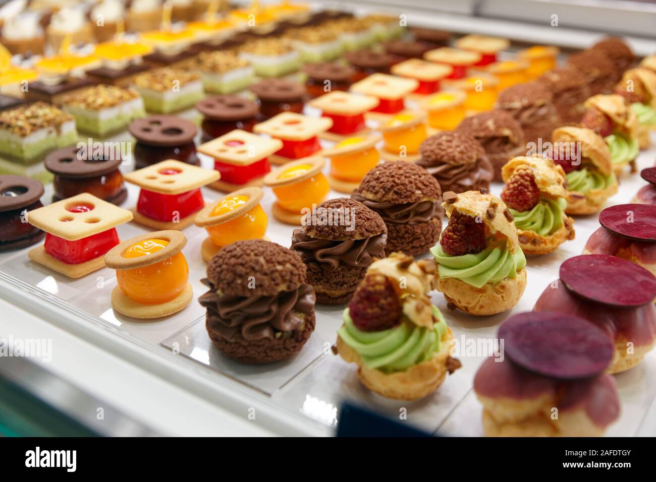 Various sweet items in window display in bakery or supermarket Stock Photo