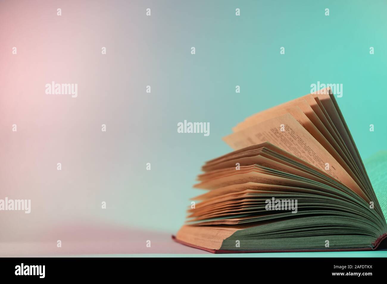 Beautiful open old book pages in neon light. Minimalism retro style  concept. 80s. Background pattern for design Stock Photo - Alamy