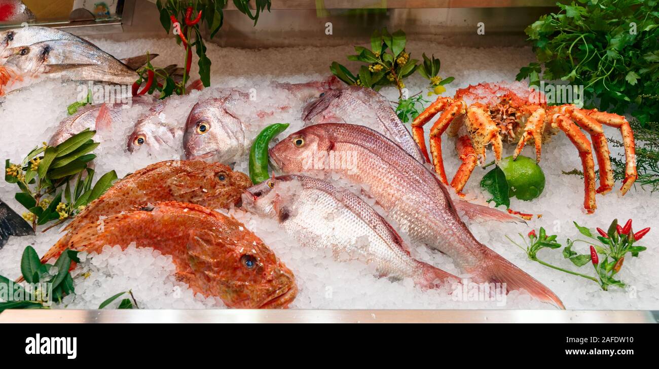 Raw fish and shellfish on iced supermarket display Stock Photo