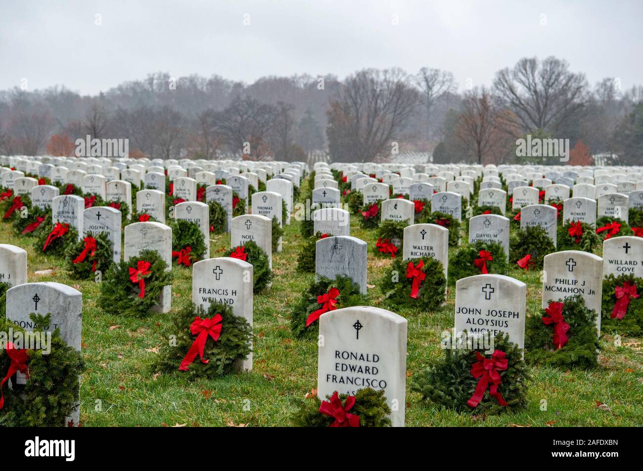 Arlington, United States of America. 14 December, 2019. Thousands of wreaths mark Section 54 on the gravesite of a fallen service member during the 28th Wreaths Across America Day at Arlington National Cemetery December 14, 2019 in Arlington, Virginia. More than 38,000 volunteers place wreaths at every gravesite at Arlington National Cemetery and other sites around the nation.  Credit: Elizabeth Fraser/DOD/Alamy Live News Stock Photo