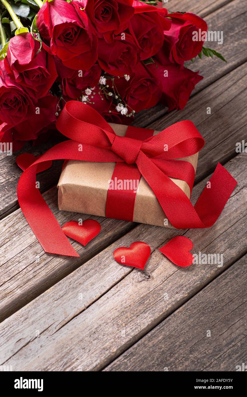 Florist Making A Red Roses Bouquet Wrapping In Kraft Paper On A Wooden  Table Top View Rustic Style Stock Photo - Download Image Now - iStock