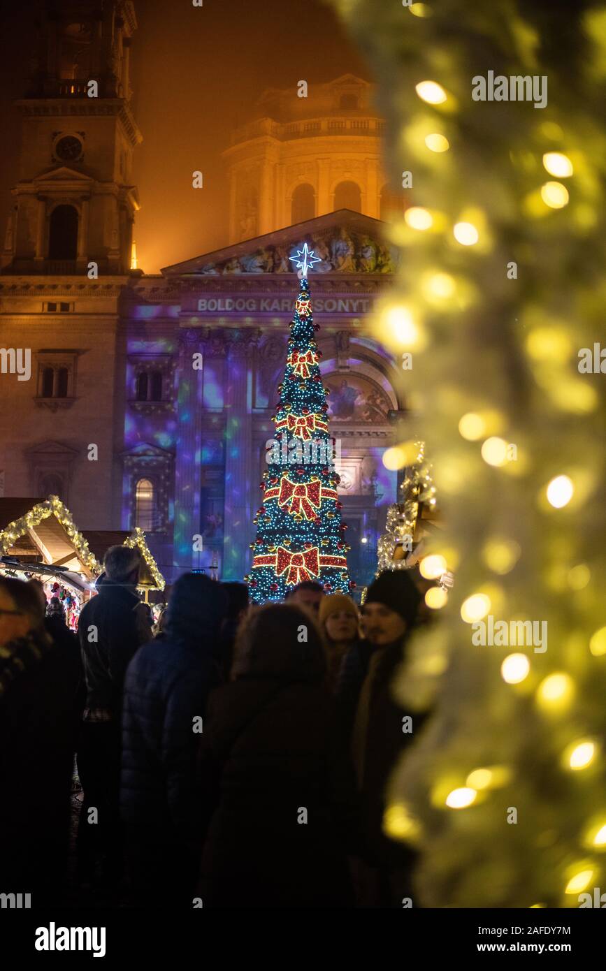 People enjoying the lights & street for atmosphere at the Budapest Christmas market Stock Photo