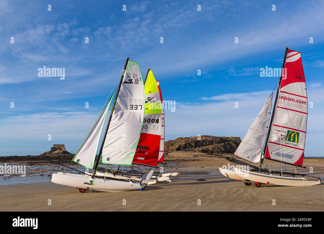 Catamarans on beach with Grand Be island and Petit Be Island in the distance at St Malo, Saint Malo, Brittany, France in December Stock Photo