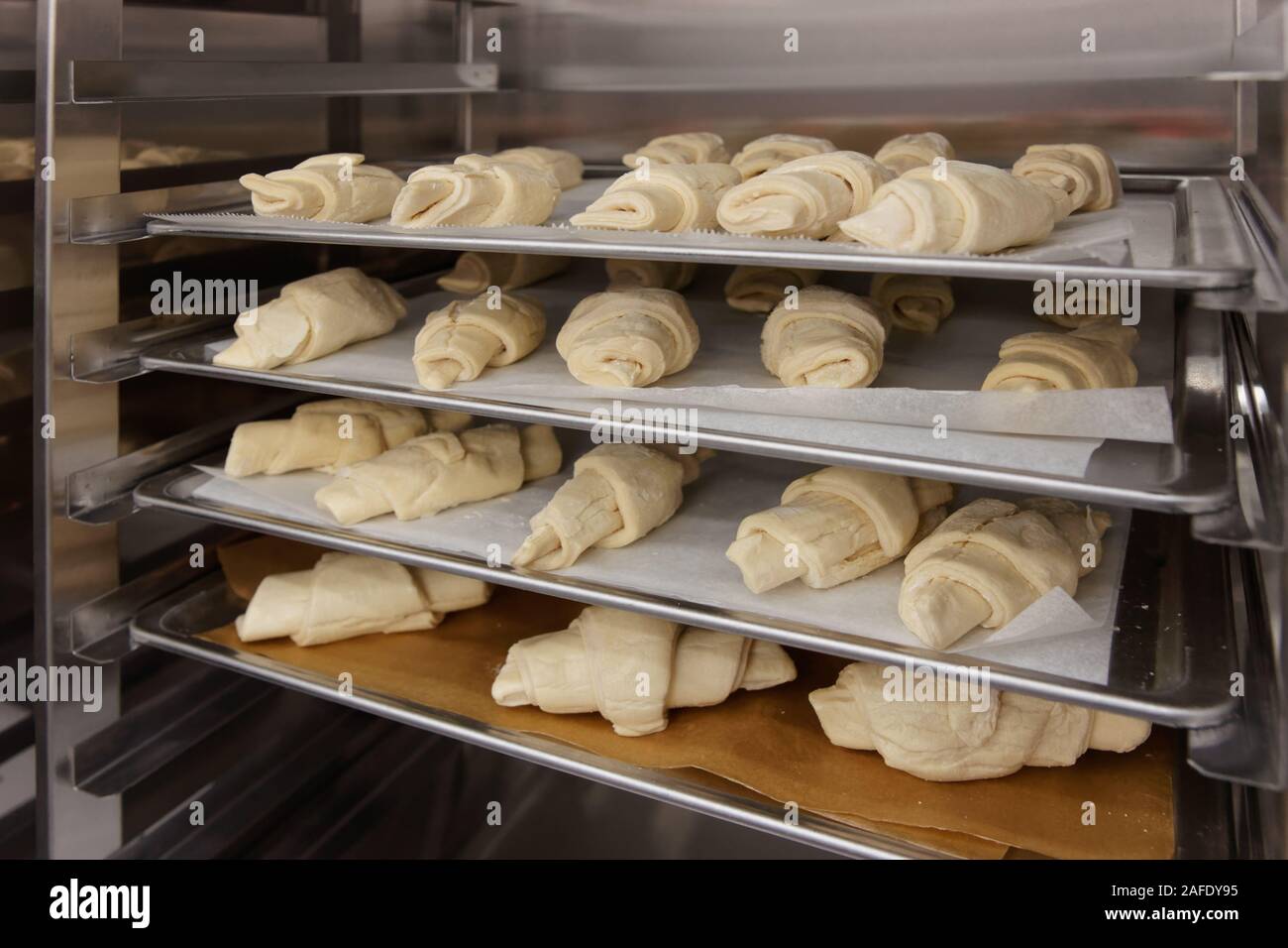 Frozen croissants and dough buns on baking sheets Stock Photo Alamy