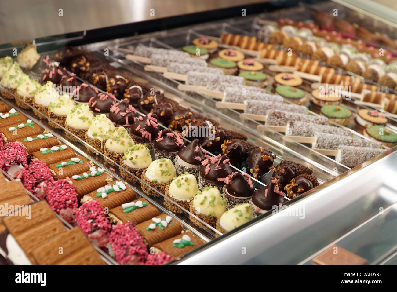 Various sweet items in window display in bakery or supermarket Stock Photo