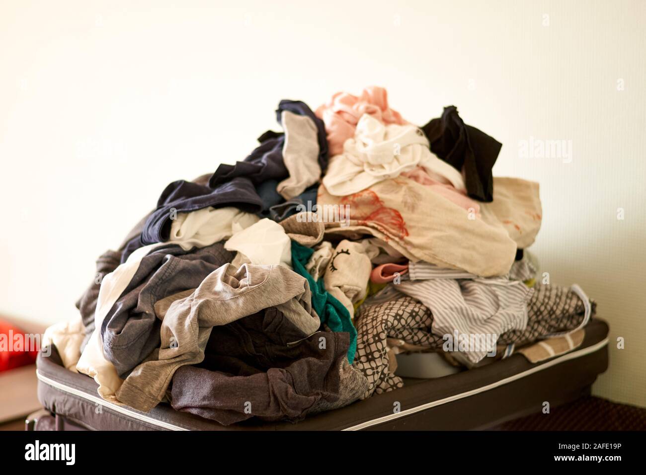 Overflowing Laundry At Home COpy Space Messy Real Life Chores Stock overflowing-laundry-at-home-copy-space-messy-real-life-chores-stock