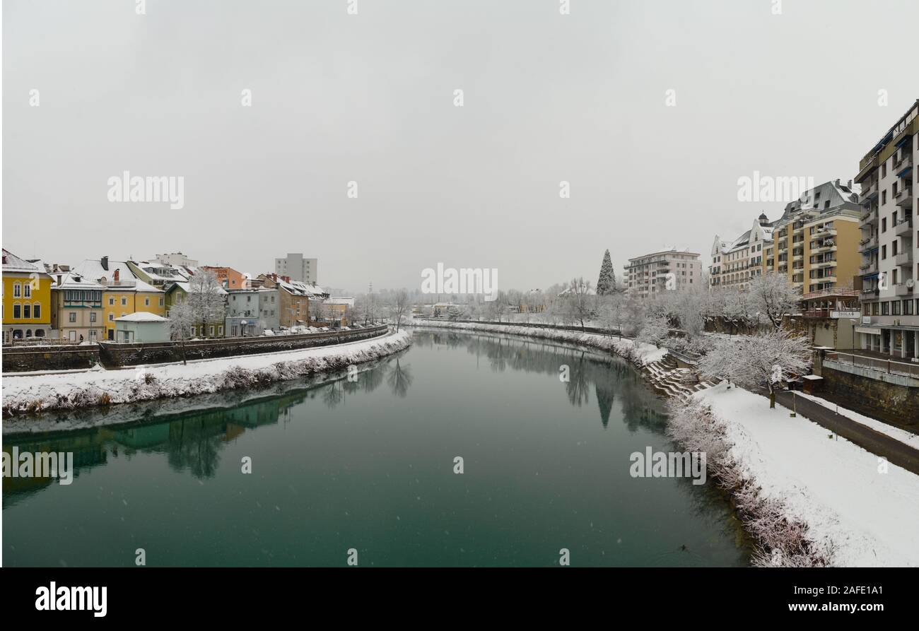 Panorama of the River Drau crossing the town of Villach in Austria in a winter day during a snow storm Stock Photo