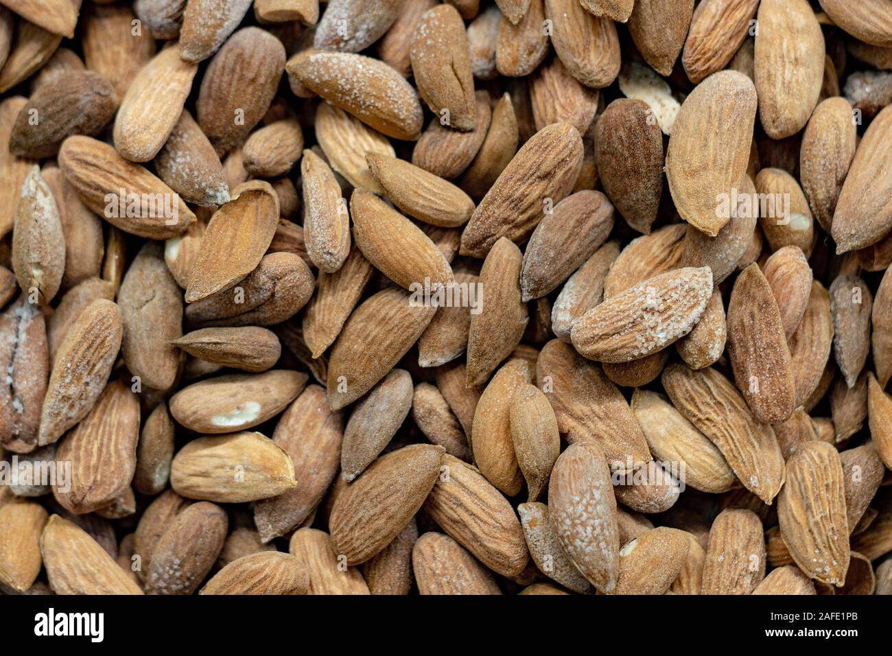 Peeled dry brown almond seed with mold plaque  in bulk. Top View. Stock Photo