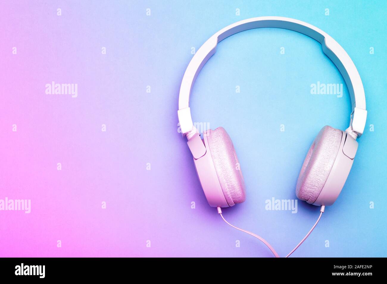 Musical headphones on a colored blue and pink background. Aesthetics retro  80s and minimal concept Stock Photo - Alamy