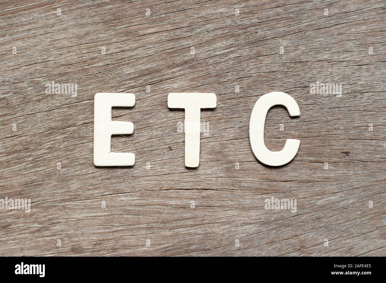 Alphabet letter in word etc (abbreviation of et cetera) on wood background Stock Photo Alamy