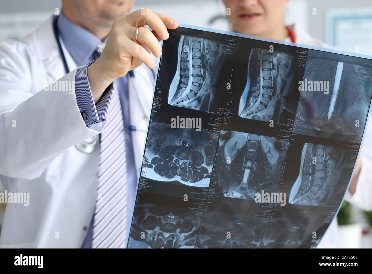 Doctor with co-worker speaking about radiogram Stock Photo