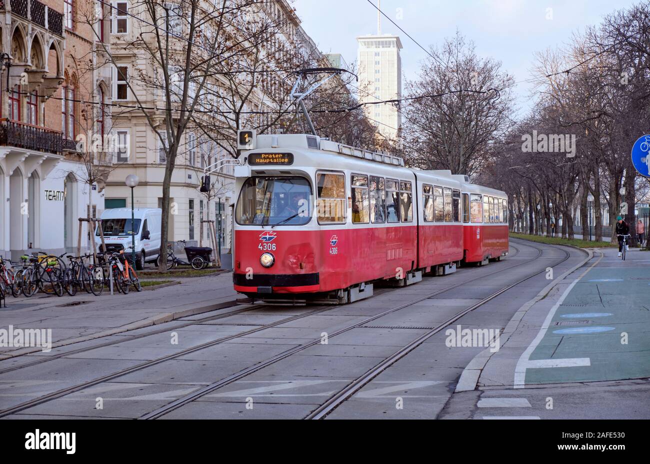 E2 type Vienna Tram riding on tracks bordered by cycling lane, and winter leafless trees Stock Photo