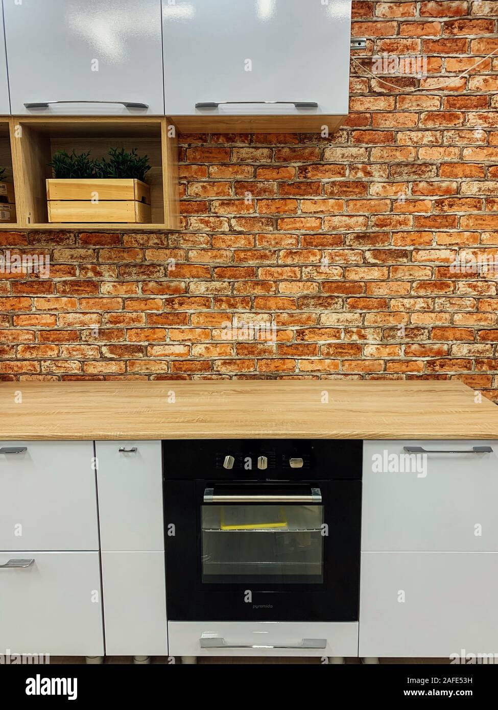 Stylish kitchen with with elegant shiny table and stove Stock Photo - Alamy