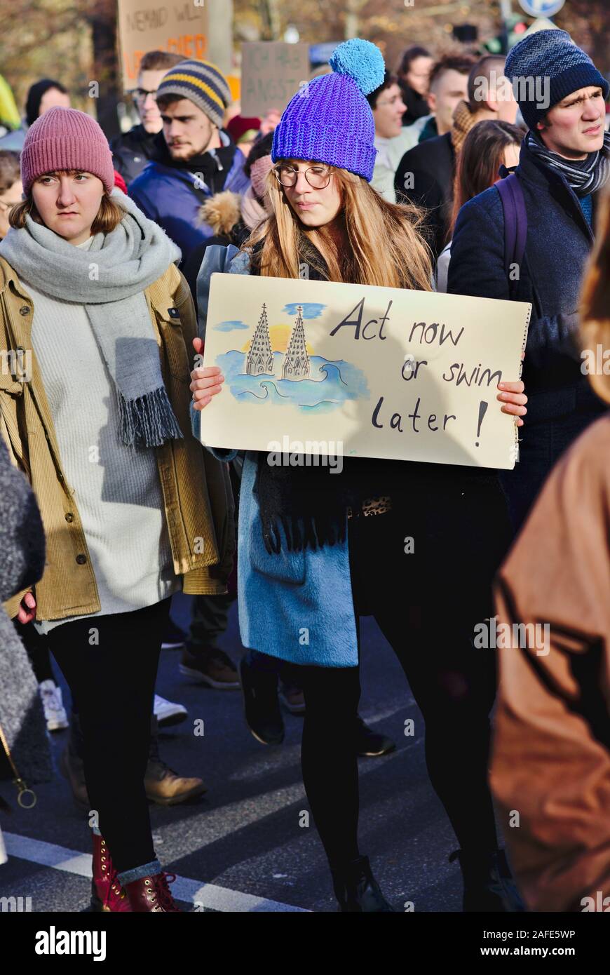 Real People carrying climate protest signs on Fridays for Future demonstration. Act now or swim later Stock Photo