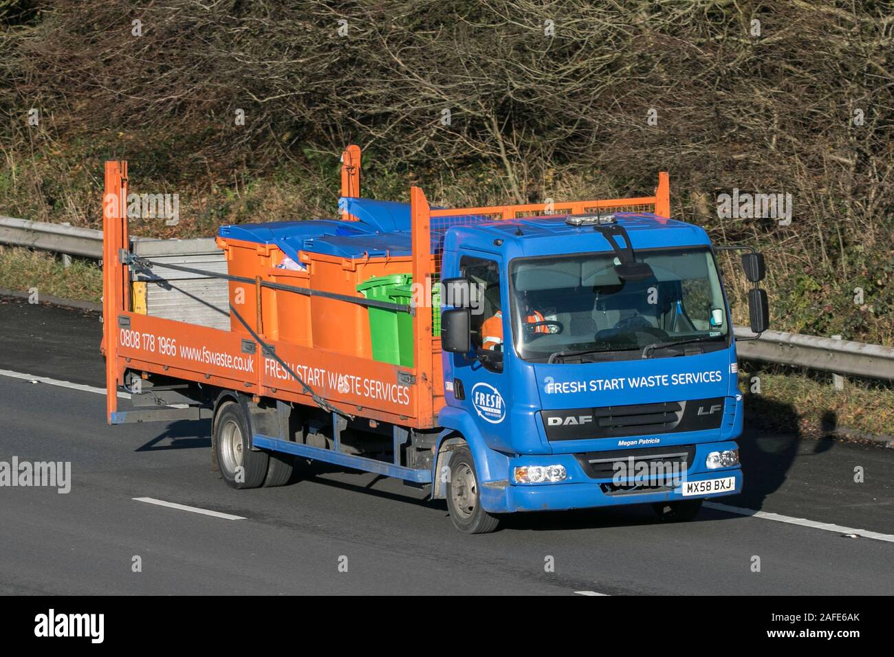 Fresh Start Waste services bin refuse collection driving on the M61 motorway near Manchester, UK Stock Photo