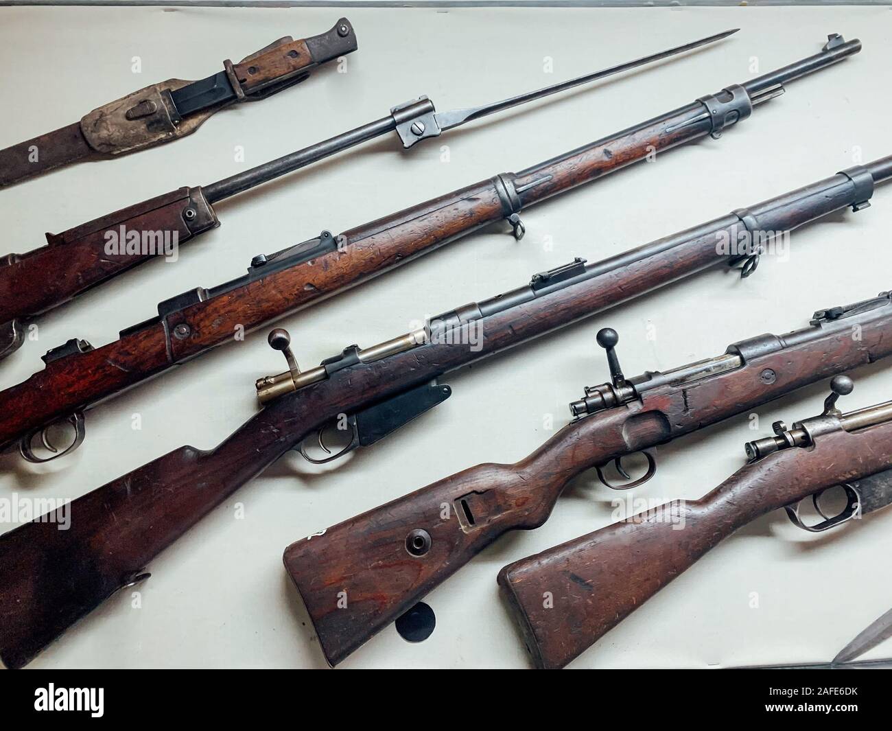 lots of old small arms on a white background Stock Photo