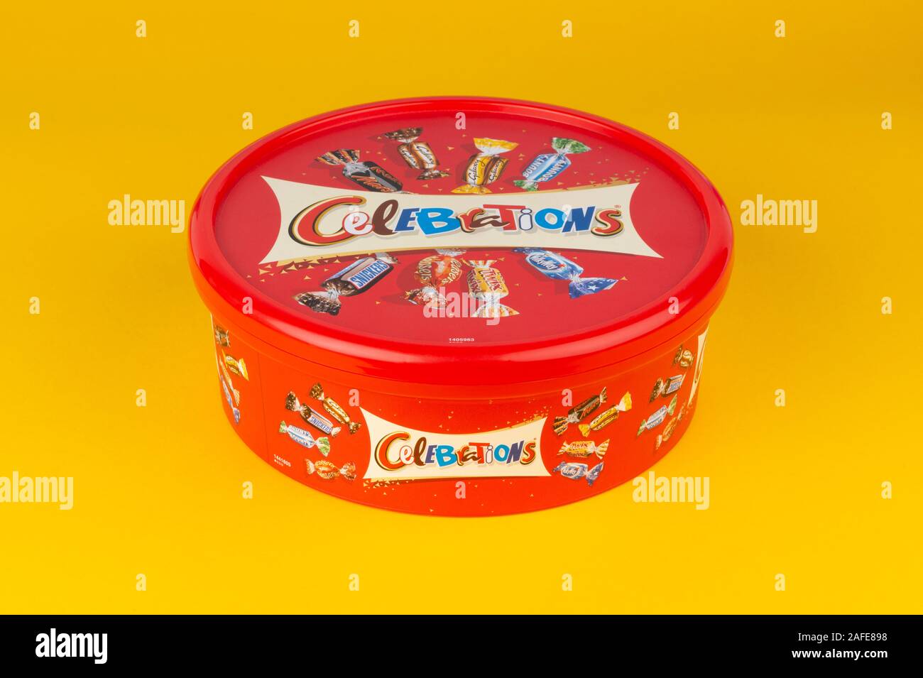A box of Celebrations chocolate confectionery shot on a yellow background. Stock Photo
