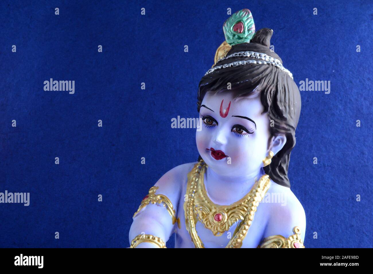 Hindu God Krishna on blue background Stock Photo - Alamy
