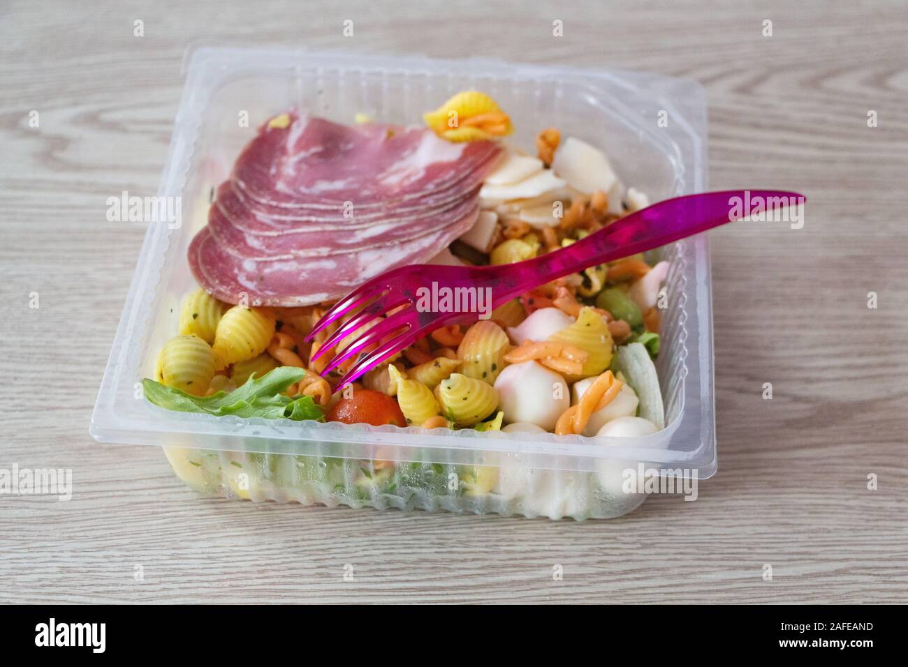 Industrial mixed salad and plastic fork Stock Photo