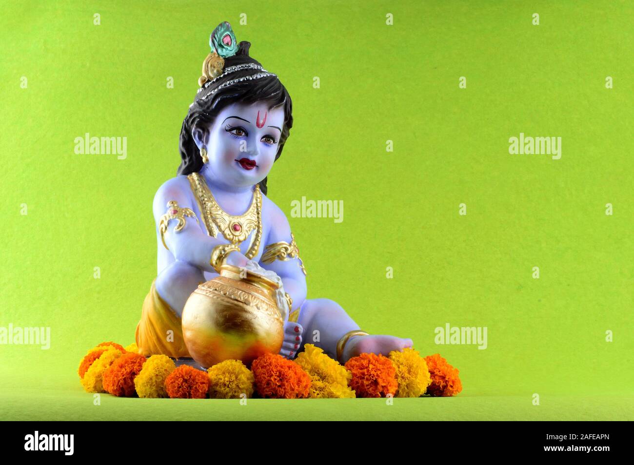 Hindu God Krishna on green background Stock Photo - Alamy