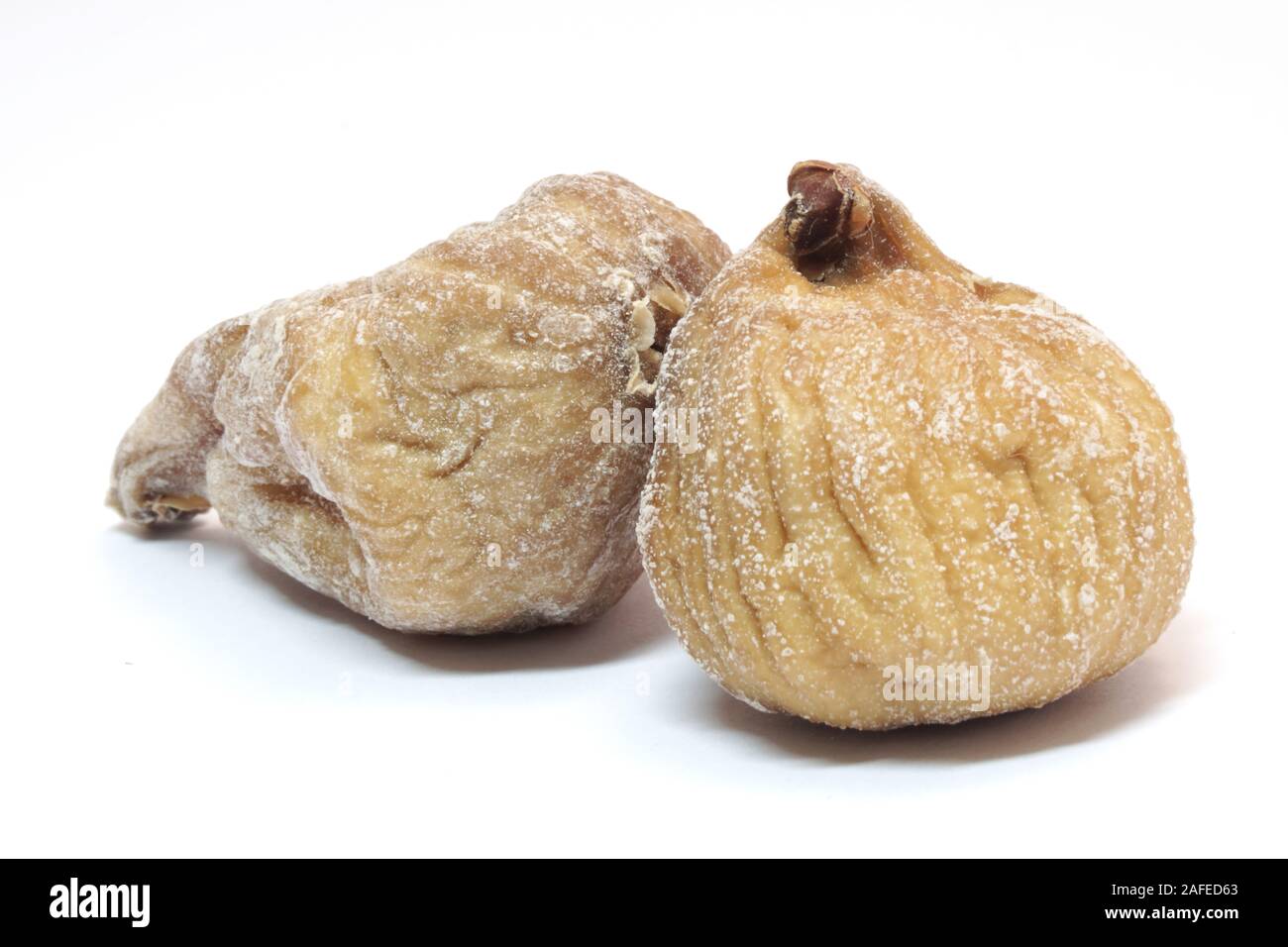Image of two dried figs isolated on white background. Stock Photo