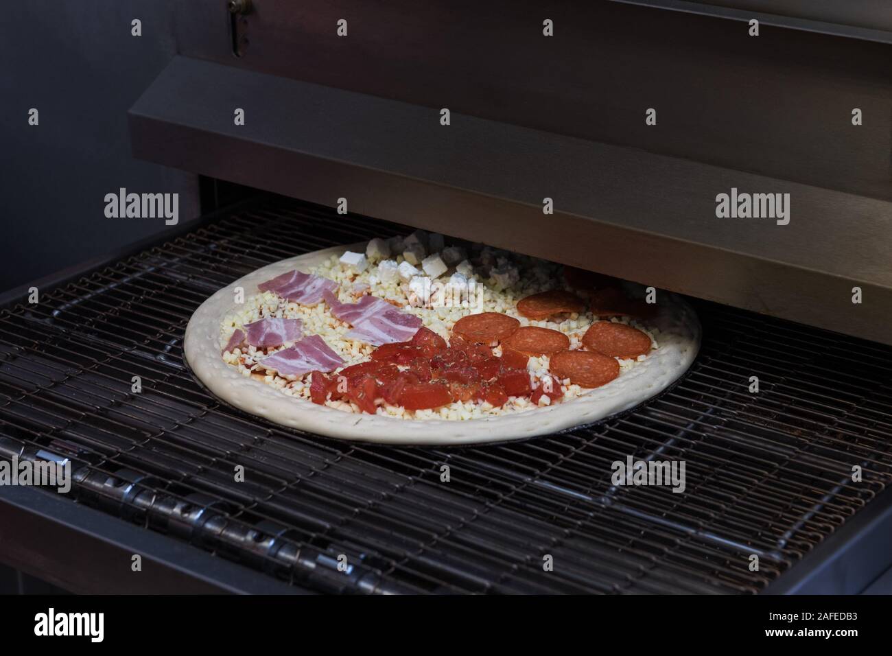 Preparing pizza in oven Stock Photo Alamy