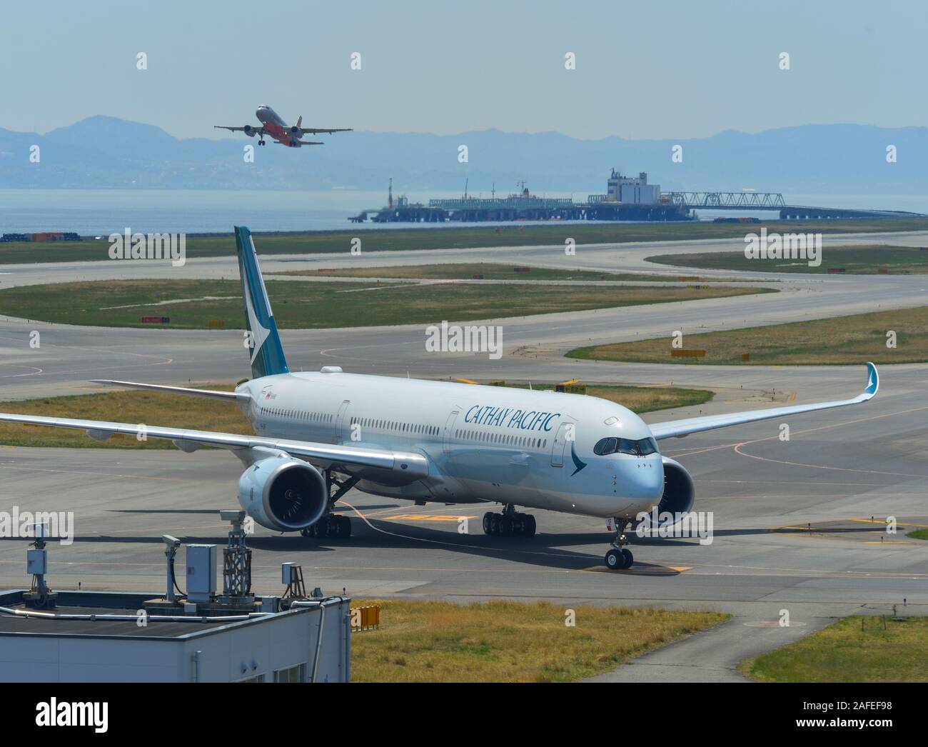 Osaka, Japan - Apr 18, 2019.  B-LXF Cathay Pacific Airbus A350-1000 taxiing on runway of Kansai Airport (KIX). Kansai is the 3rd busiest in Japan, wit Stock Photo