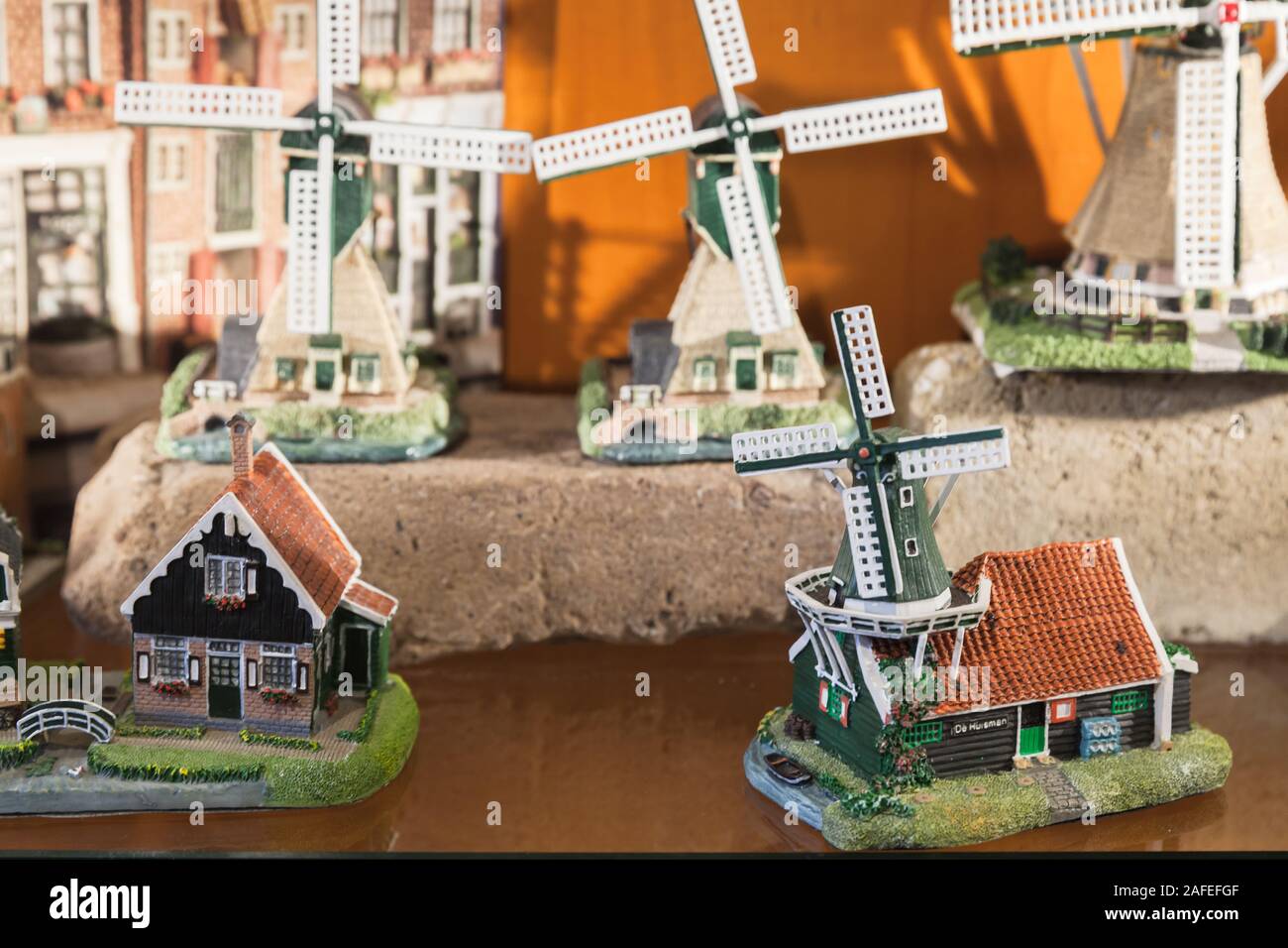 Amsterdam, Netherlands - February 25, 2017: Miniature windmills and houses, souvenirs of Amsterdam stand on a counter of gift shop Stock Photo
