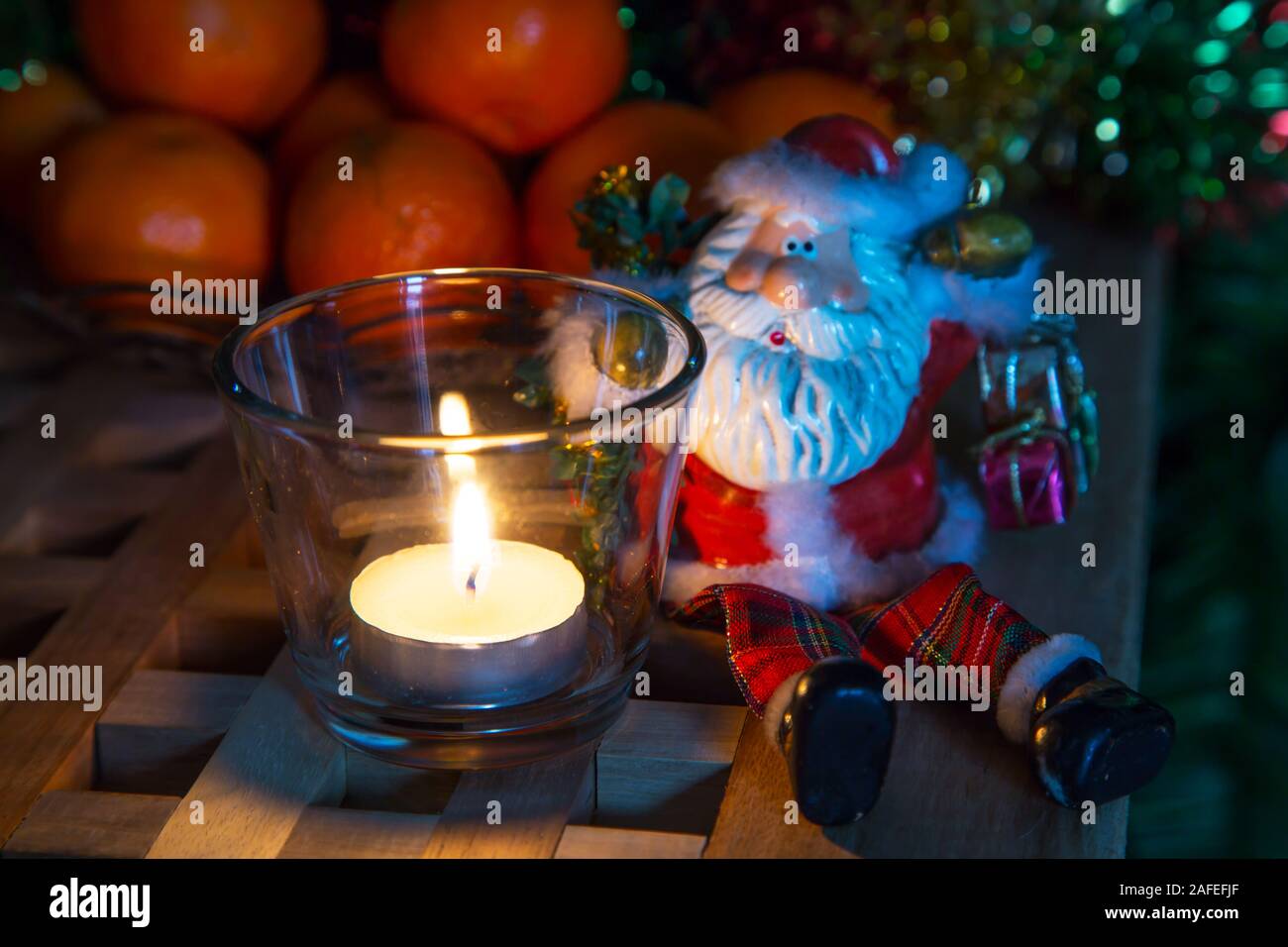 Christmas Eve Background With Tea Candles Toy Santa And Christmas Decorations Stock Photo Alamy