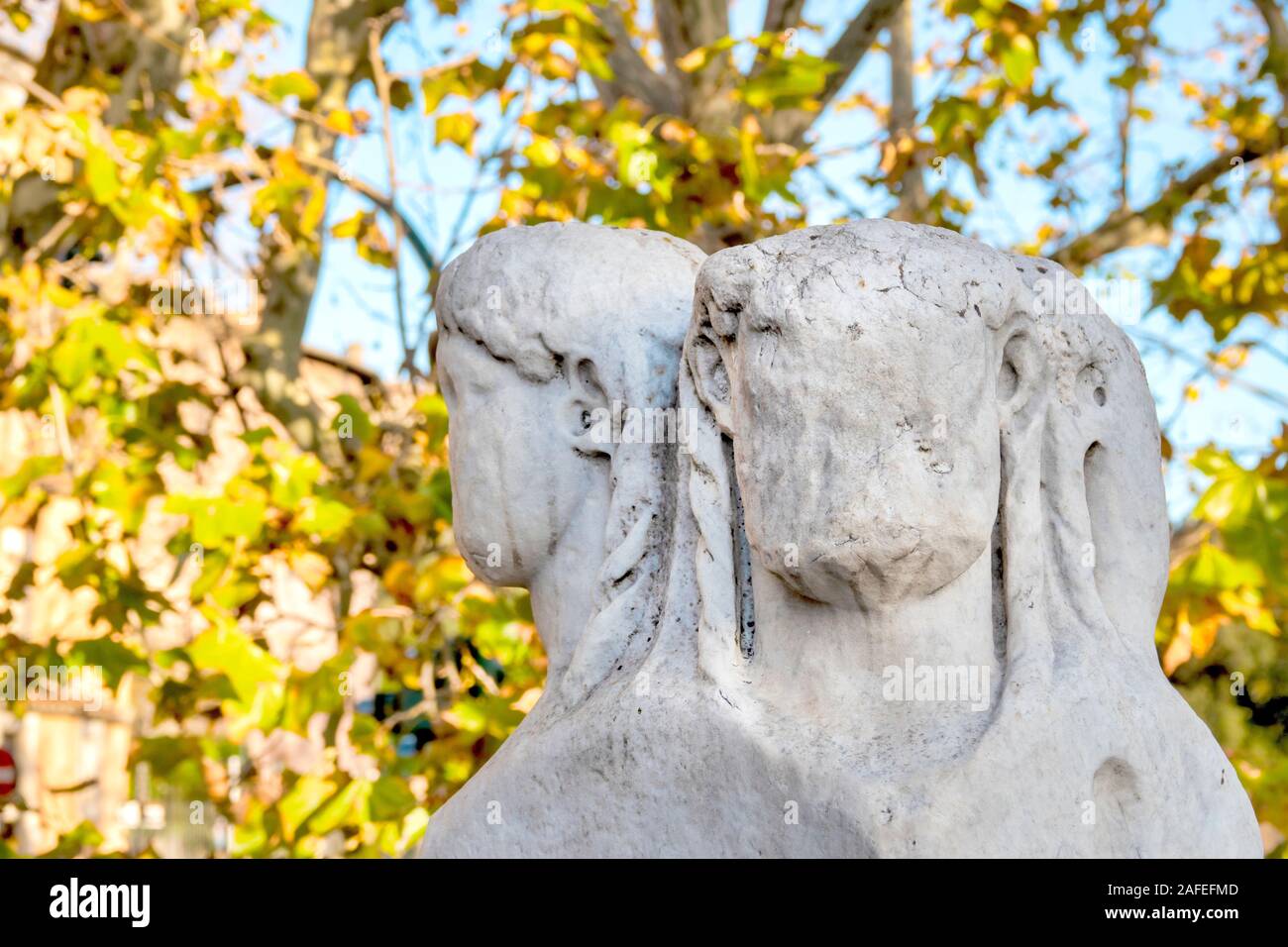 Marble pillar depicting Janus on Ponte Fabricio, Rome Italy Stock Photo