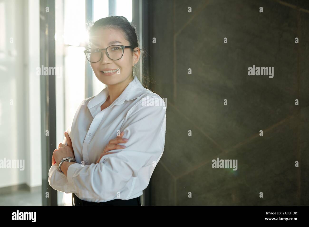 Smiling asian businesswoman arms hi-res stock photography and images ...