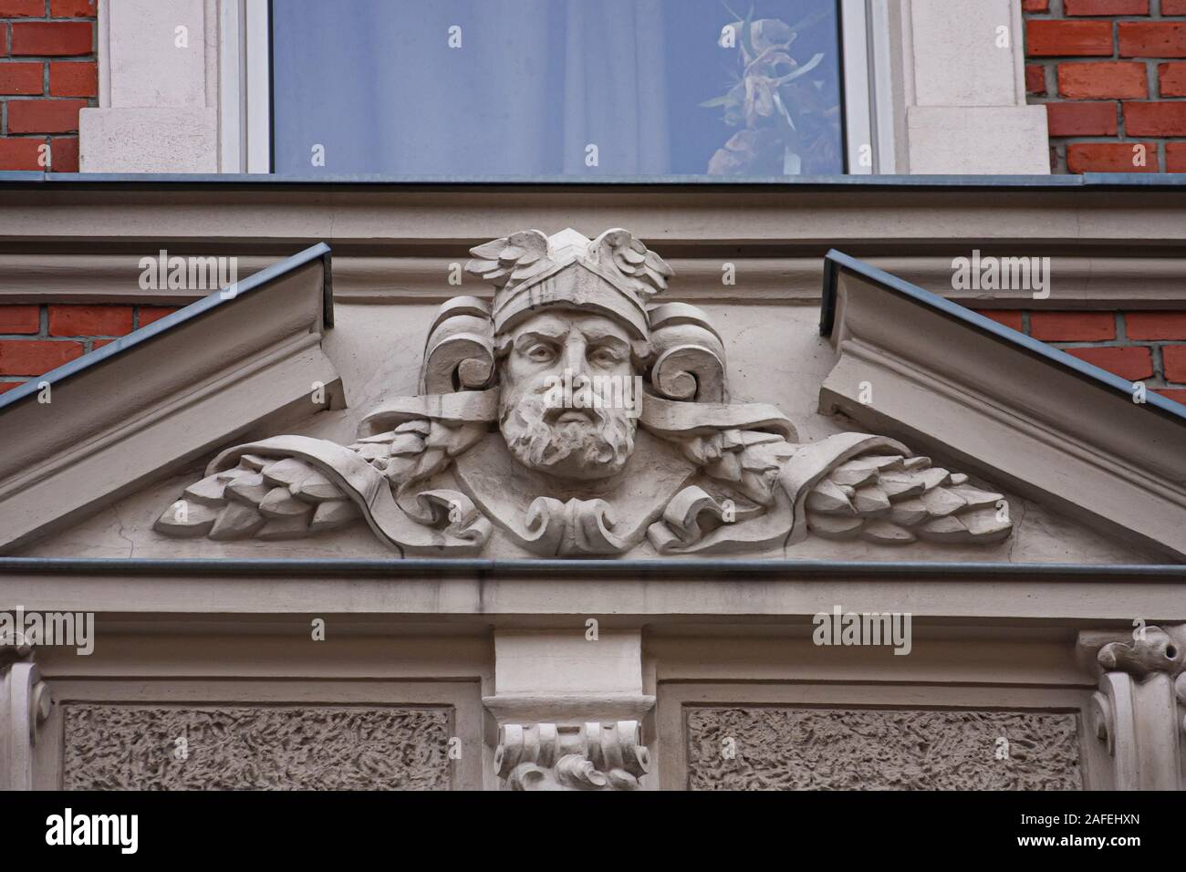 Mascaron face architecture elements decoration red-brick german style tenement wall stucco texture reference Stock Photo