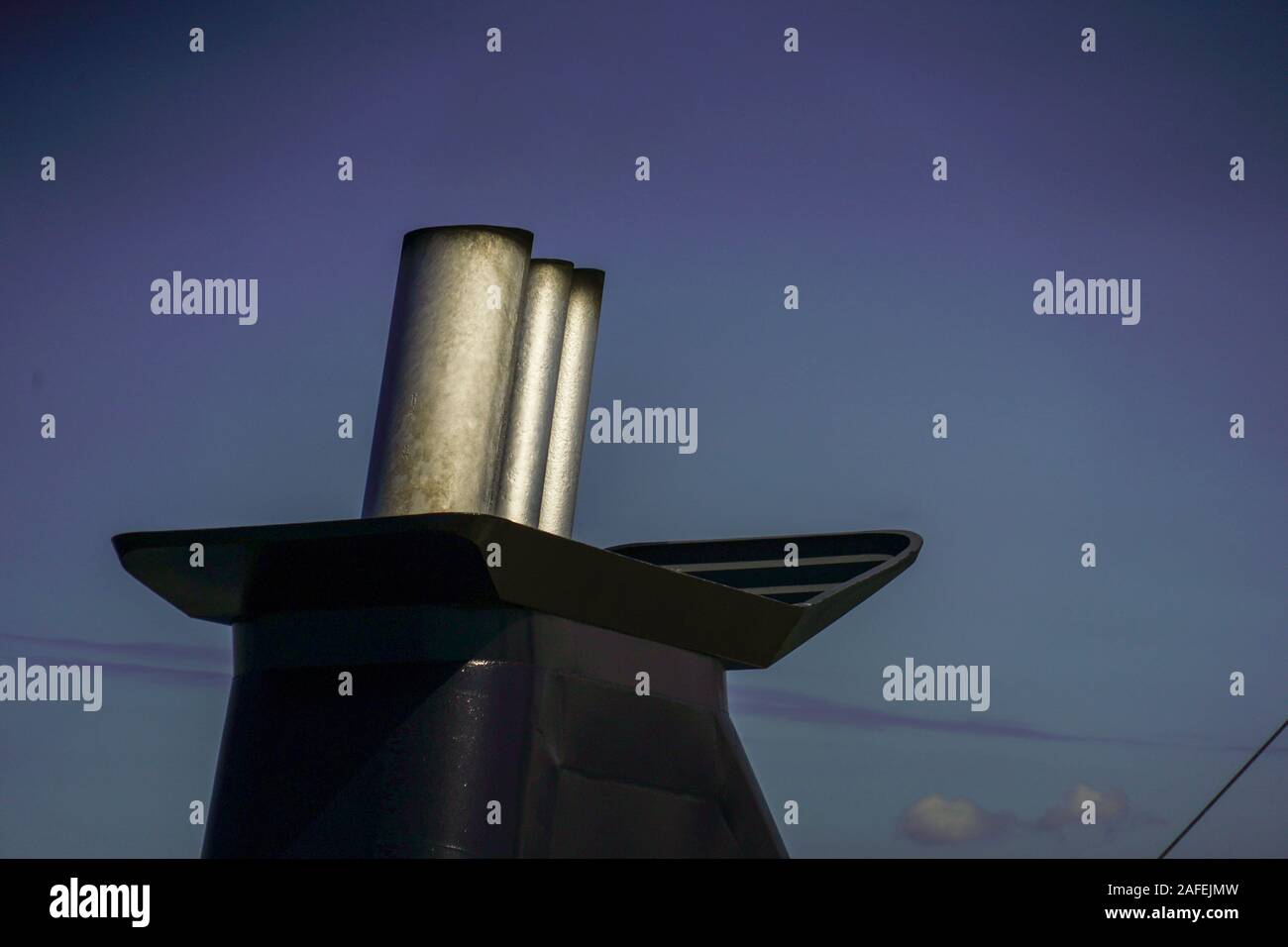 exhaust pipe emitting smoke and fumes from a maritime diesel engine on