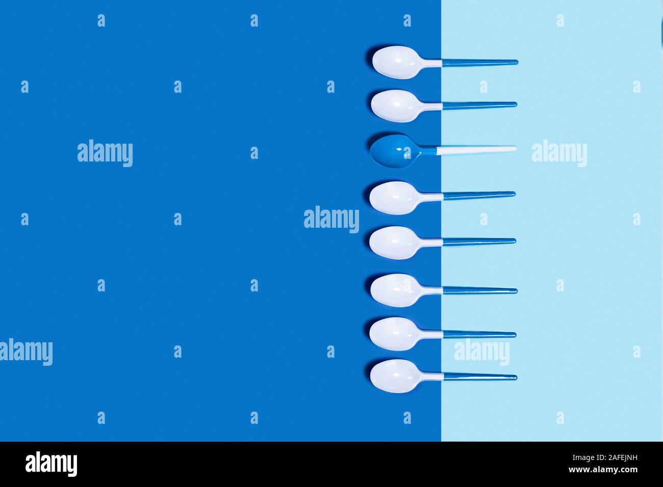 Dangerous and needed group of plastic spoons. Environmental problem of